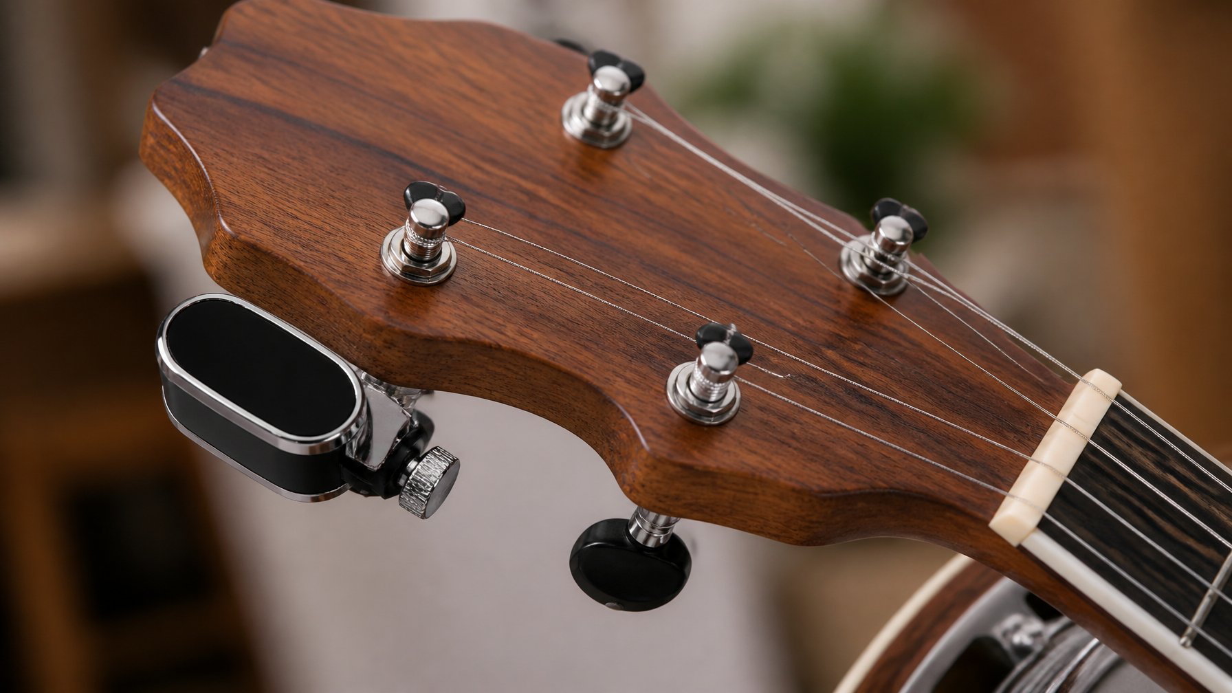 Close-up of a D'Addario Micro Headstock Banjo Tuner attached to a banjo headstock.